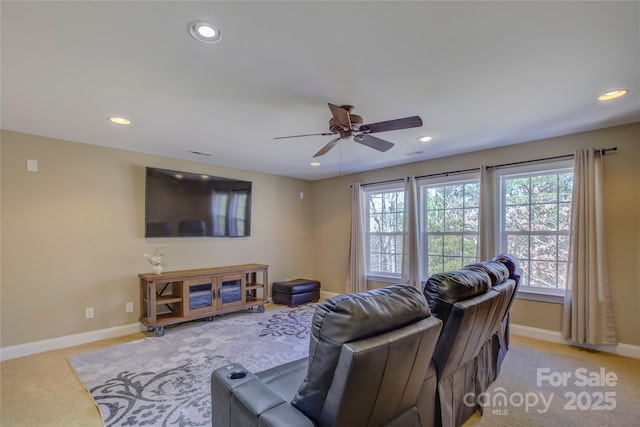 carpeted living room with ceiling fan and a healthy amount of sunlight