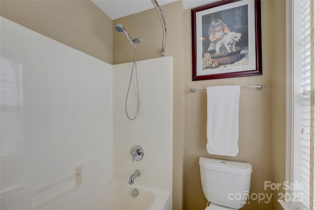 bathroom with toilet and tub / shower combination