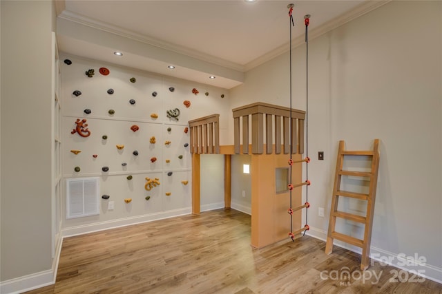 interior space featuring hardwood / wood-style floors and ornamental molding