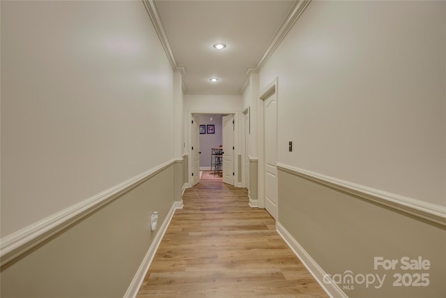 corridor with crown molding and light hardwood / wood-style flooring