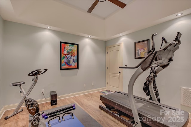 workout room featuring ceiling fan and light wood-type flooring