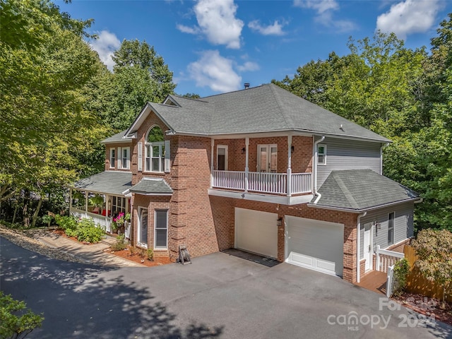 view of front of property featuring a garage and a balcony