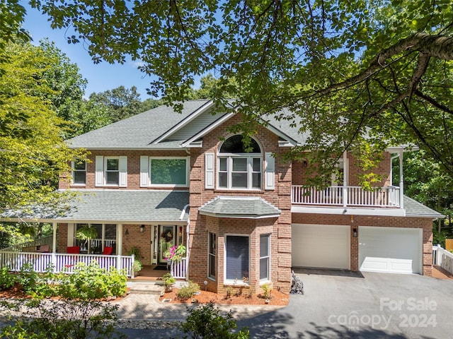 view of front of property with a porch and a garage