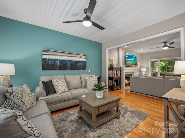 living room with hardwood / wood-style flooring and ceiling fan