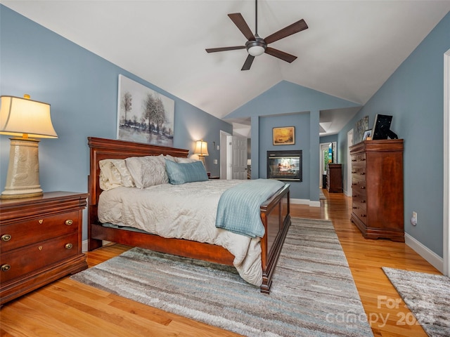 bedroom featuring ceiling fan, vaulted ceiling, and light hardwood / wood-style flooring