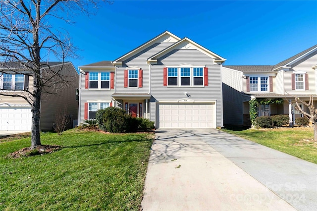 view of front of property with a front lawn and a garage