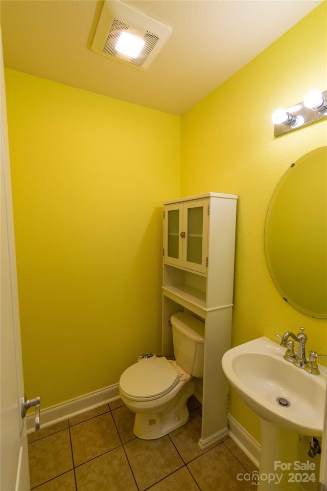 bathroom with tile patterned flooring, toilet, and sink