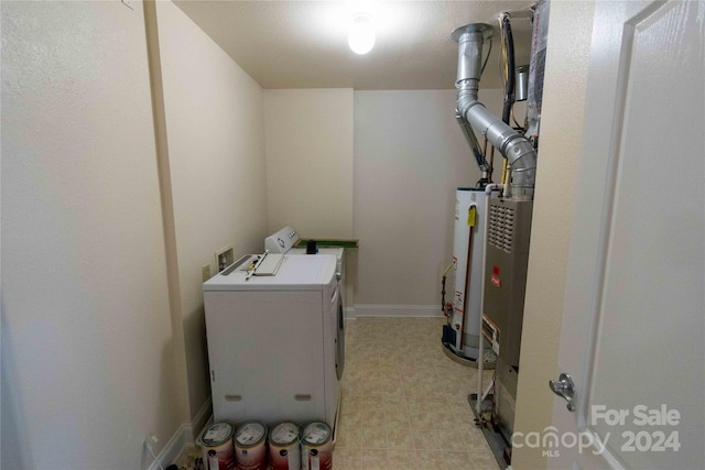 washroom with washer and clothes dryer and water heater