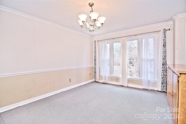 carpeted empty room with ornamental molding and a chandelier