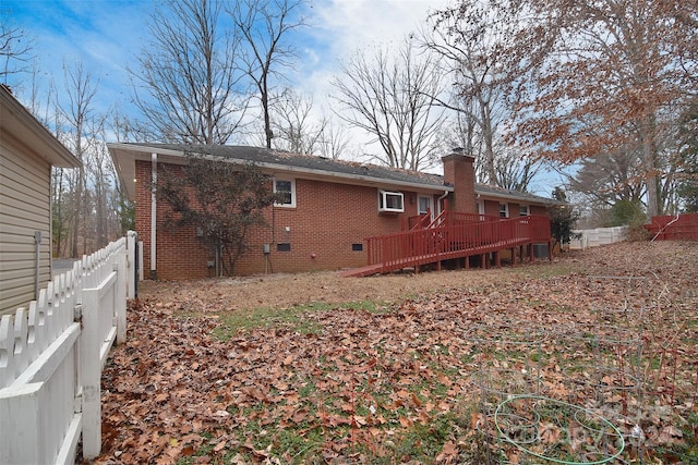 rear view of house with a wooden deck