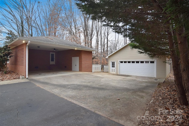 view of home's exterior featuring an outbuilding, a carport, and a garage