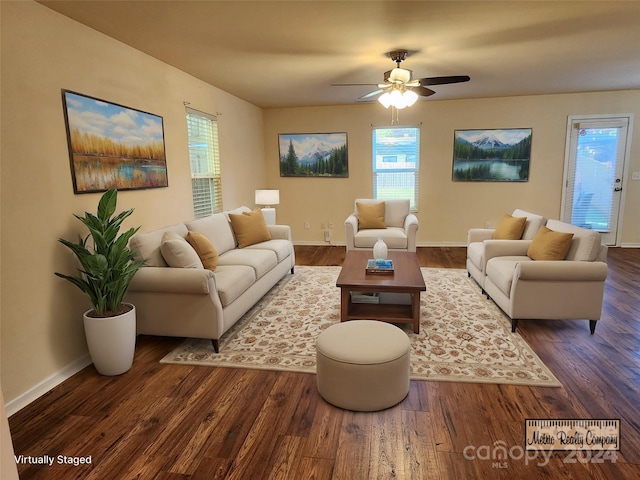 living room featuring a wealth of natural light, ceiling fan, and dark wood-type flooring