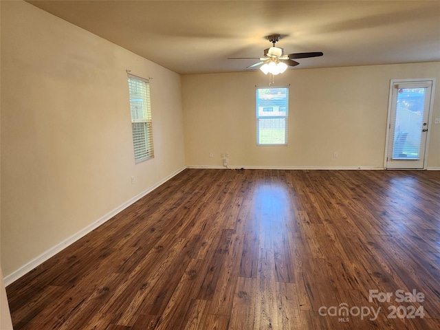 unfurnished room with dark hardwood / wood-style floors and ceiling fan