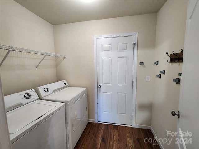 laundry area with independent washer and dryer and dark hardwood / wood-style floors