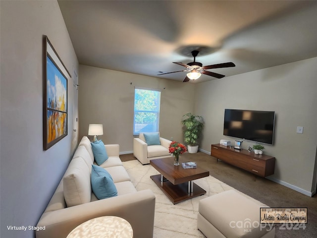 carpeted living room featuring ceiling fan