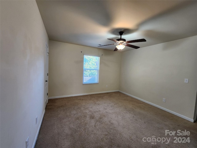 empty room featuring ceiling fan and carpet floors