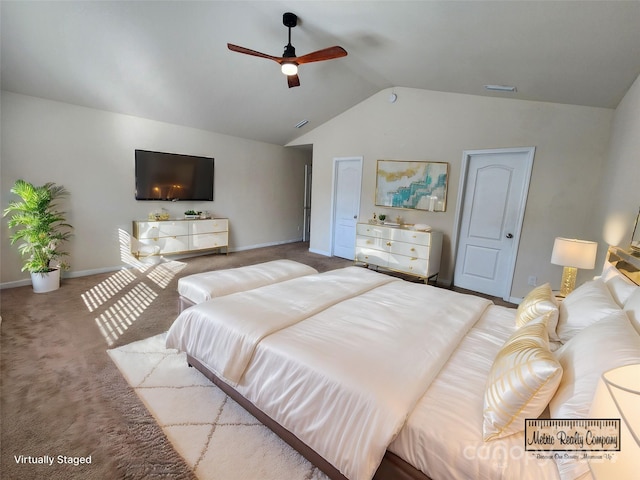 carpeted bedroom with ceiling fan and vaulted ceiling