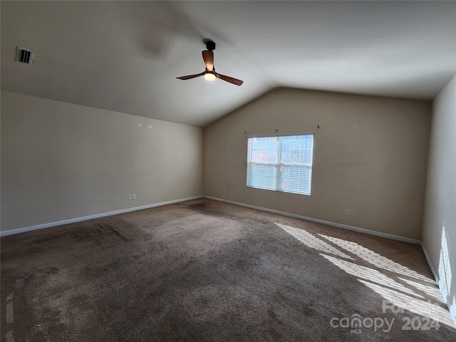 interior space with carpet floors, ceiling fan, and lofted ceiling