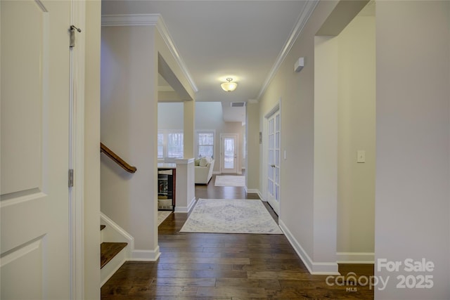 entryway featuring dark hardwood / wood-style flooring and ornamental molding