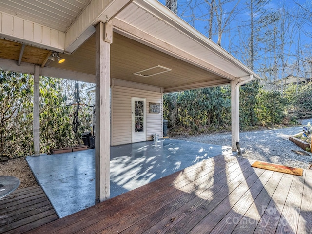 wooden terrace featuring a patio area