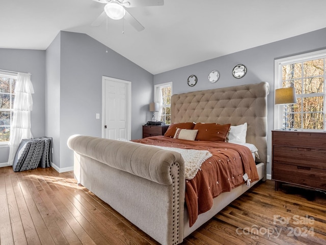 bedroom with ceiling fan, dark hardwood / wood-style floors, lofted ceiling, and multiple windows