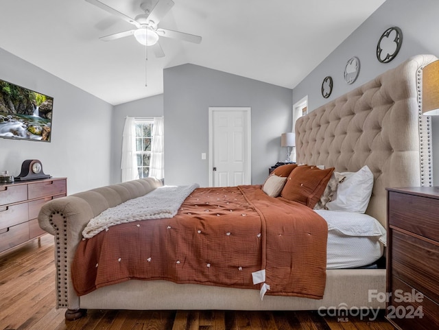 bedroom featuring ceiling fan, hardwood / wood-style floors, and vaulted ceiling