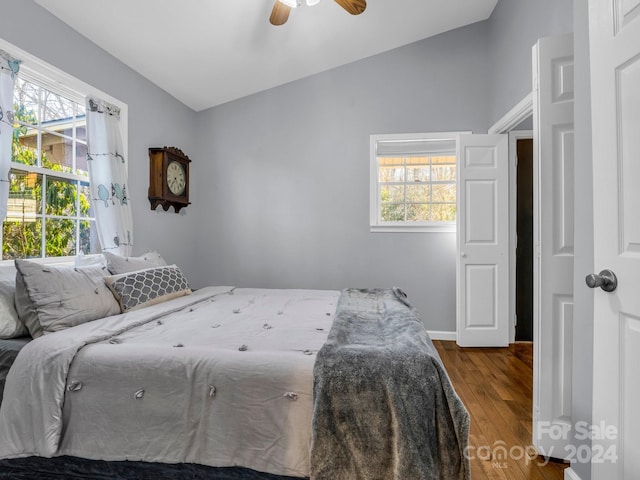 bedroom with ceiling fan, wood-type flooring, and vaulted ceiling