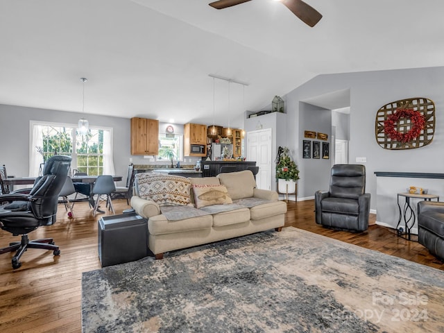 living room featuring ceiling fan, dark hardwood / wood-style flooring, lofted ceiling, and sink