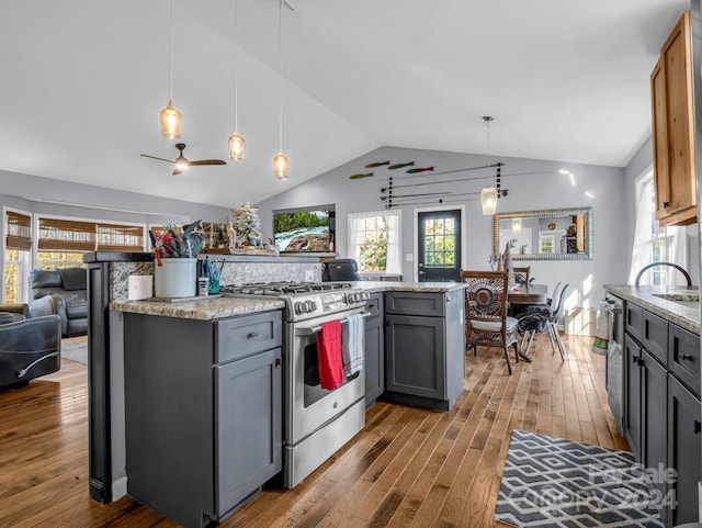 kitchen with pendant lighting, hardwood / wood-style flooring, gray cabinets, light stone countertops, and appliances with stainless steel finishes