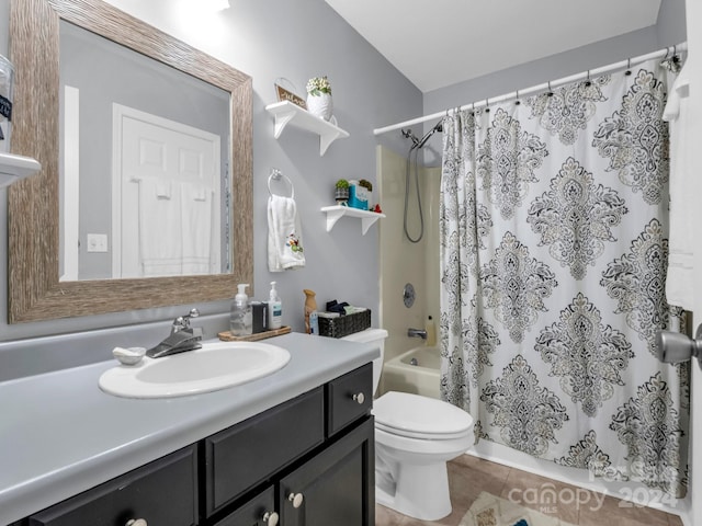 full bathroom featuring tile patterned flooring, shower / tub combo with curtain, vanity, and toilet