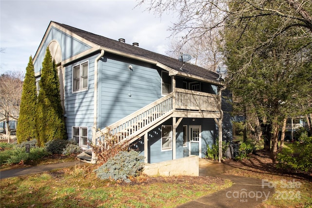 back of house featuring a balcony