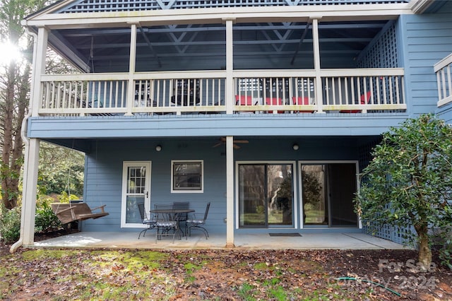 rear view of house with ceiling fan and a patio