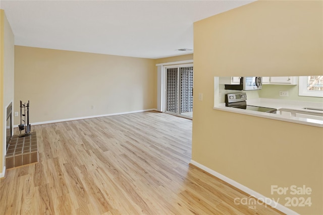 unfurnished living room featuring light hardwood / wood-style floors