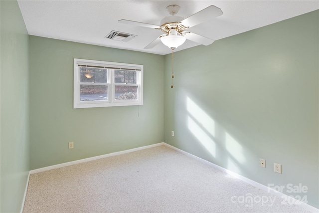 spare room with carpet and ceiling fan