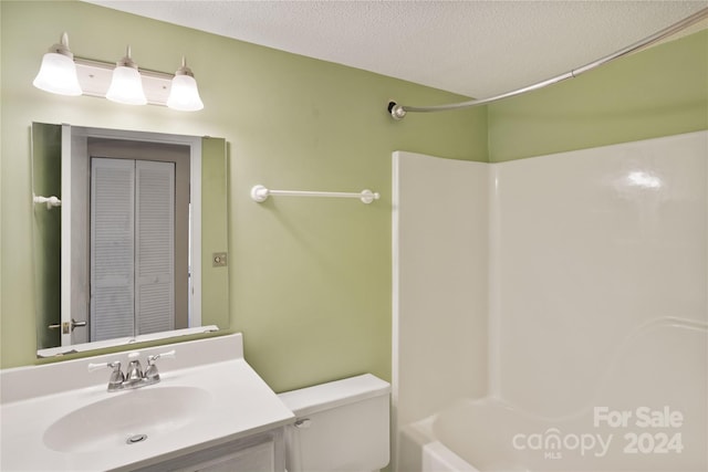 full bathroom with vanity, shower / bathtub combination, toilet, and a textured ceiling