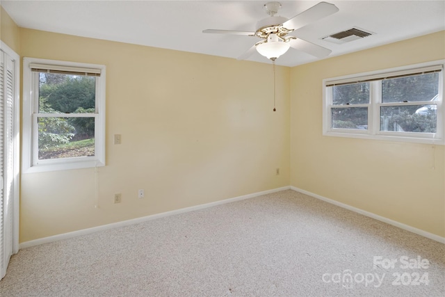 spare room with carpet flooring and ceiling fan