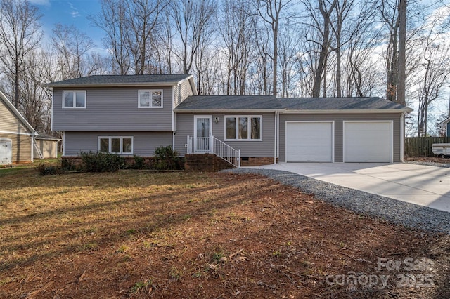 split level home featuring a front lawn and a garage