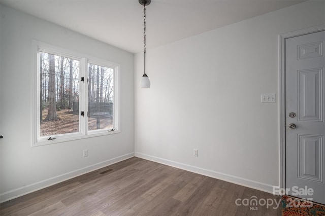 unfurnished dining area with hardwood / wood-style flooring