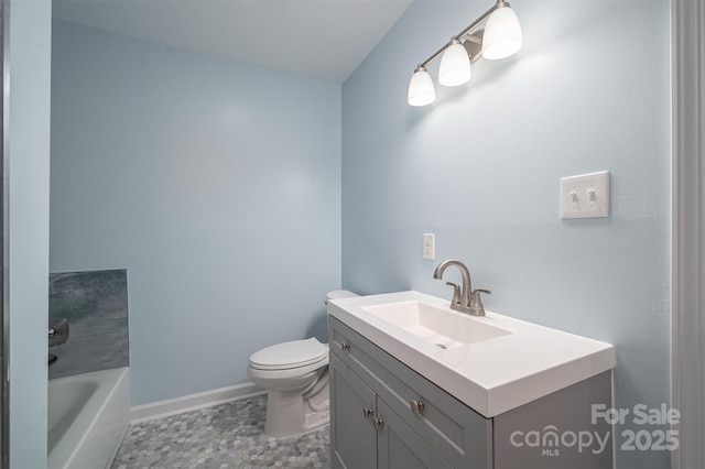 bathroom with a tub, toilet, and vanity