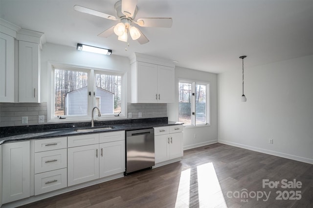 kitchen featuring ceiling fan, pendant lighting, stainless steel dishwasher, sink, and white cabinets