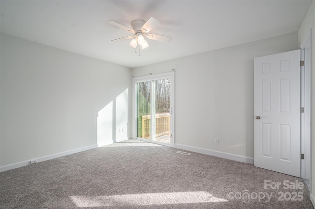 carpeted spare room featuring ceiling fan