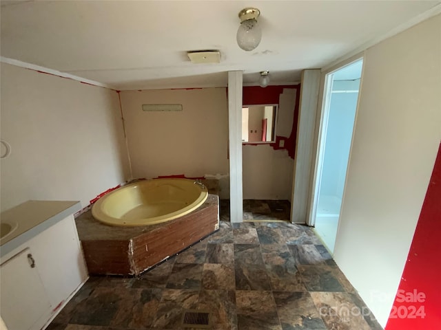 bathroom featuring a bath and vanity