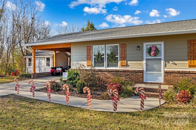 exterior space with a storage unit and a front lawn