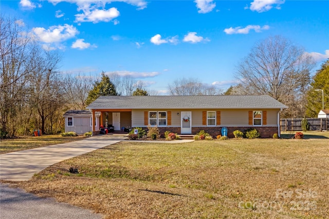 ranch-style house with an outbuilding and a front yard