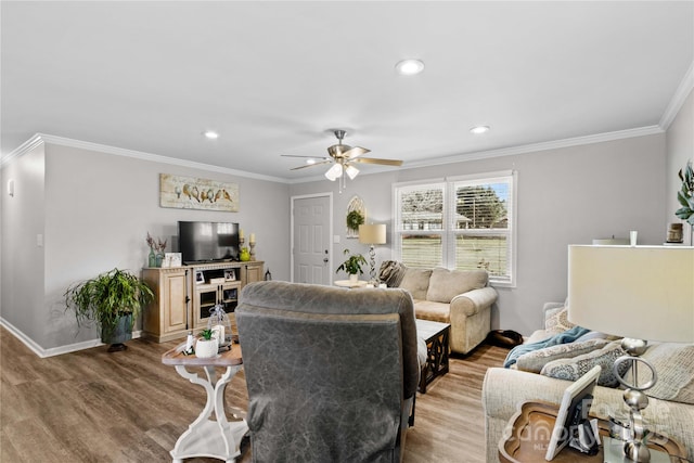 living room with hardwood / wood-style flooring, crown molding, and ceiling fan