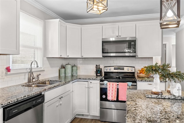 kitchen featuring light stone counters, appliances with stainless steel finishes, sink, and white cabinets