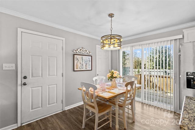 dining area featuring crown molding, dark hardwood / wood-style flooring, and a chandelier