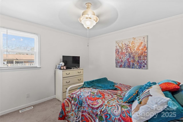 carpeted bedroom featuring ornamental molding and ceiling fan