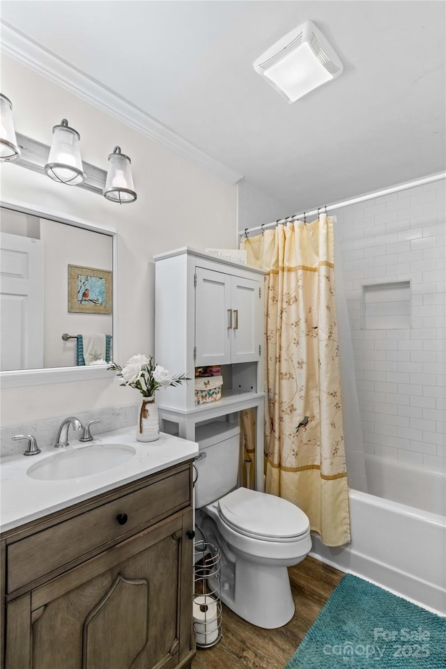 full bathroom with shower / bathtub combination with curtain, hardwood / wood-style floors, crown molding, and vanity