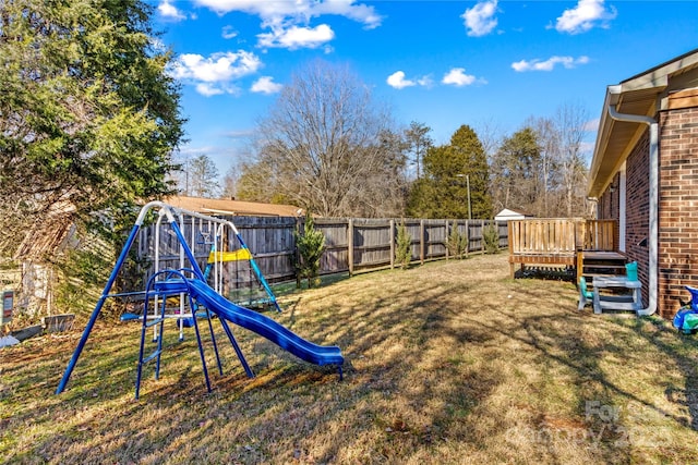 view of yard featuring a playground and a wooden deck